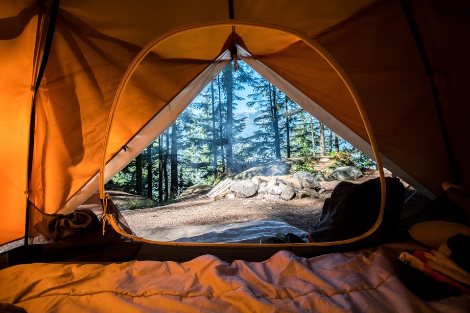 Tents and caravans at a UK campsite listed across multiple booking platforms