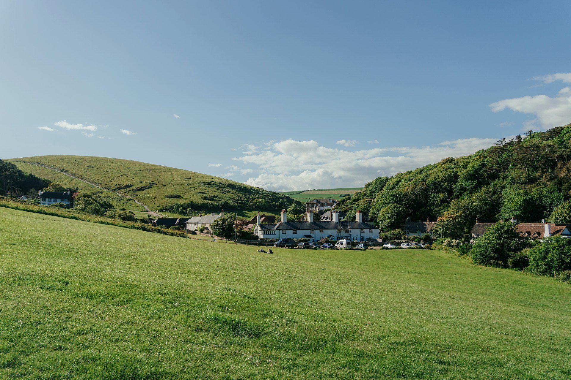 Sunset over a campsite with caravans and tents, perfect for evening events