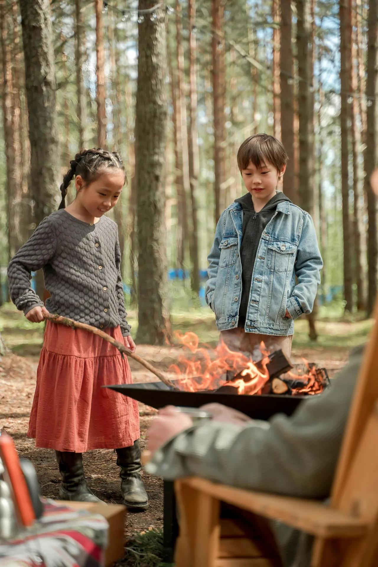 Children toasting marshmallows by the campfire